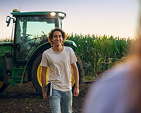 agricultural student in a field with a tractor