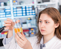 a student prepares a beaker in a lab