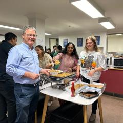 Professor Nigel Perkins collects a meal at the dinner